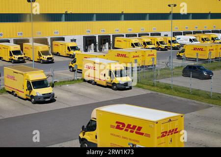 09.05.2023, Germany, Berlin, Berlin - Delivery vehicles at a DHL parcel centre in Berlin-Neukoelln. 00R230509D109CAROEX.JPG [MODEL RELEASE: NOT APPLIC Stock Photo