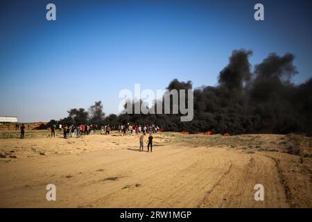 Gaza, Palestine. 15th Sep, 2023. Palestinian protesters gather during a demonstration along the border fence with Israel, east of Gaza City Palestinian protesters burn tires during clashes with Israeli security forces along the frontier with Israel, east of Gaza City. Palestinians protested near the border fence with Israel. The Gaza Health Ministry said a number of people were wounded by Israeli fire and tear gas. (Photo by Nidal Alwaheidi/SOPA Images/Sipa USA) Credit: Sipa USA/Alamy Live News Stock Photo