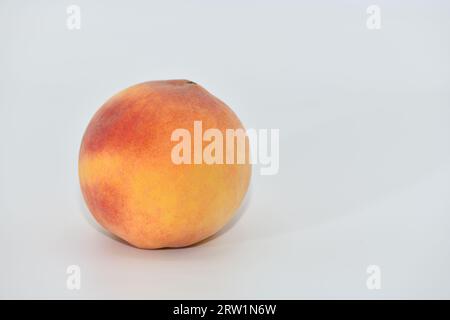 Peaches stacked in three on a white background. Stock Photo