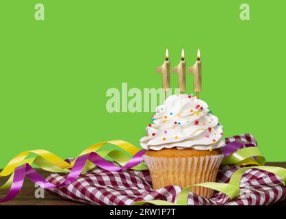 Birthday Cake With Candle Number 111 - On Green Background. Stock Photo