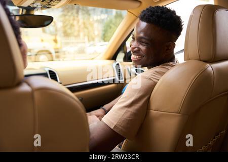 Married African American couple communicates cheerfully in a comfortable car Stock Photo