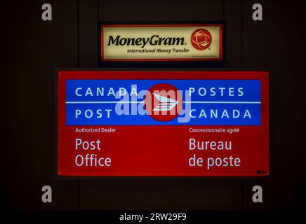 CANADA POST and MONEYGRAM banners at Post Office Outlet in English and French. Canada. Halifax, NS Stock Photo