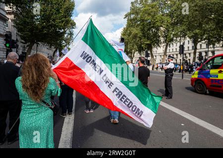 London, UK.  16 September 2023.  People in Whitehall at a solidarity rally with the people of Iran to mark the one year anniversary of the death of Mahsa Amini.  The 22 year old Kurdish woman died following arrest for allegedly breaching the country’s strict dress code.  Credit: Stephen Chung / Alamy Live News Stock Photo