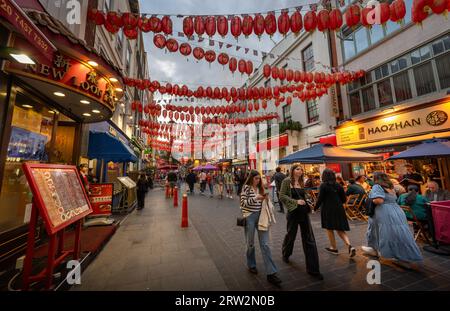 London, UK: Gerard Street in London's Chinatown. Tourist street in central London with Chinese restaurants and red Chinese lanterns. Stock Photo