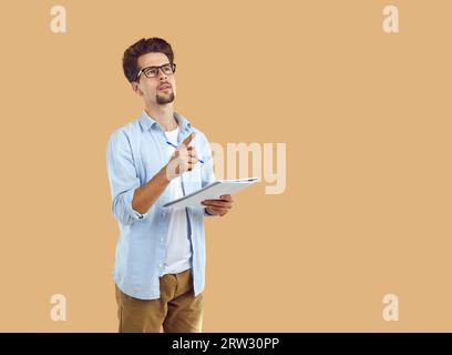 inspired man holding notebook pointing index finger up having new idea Stock Photo