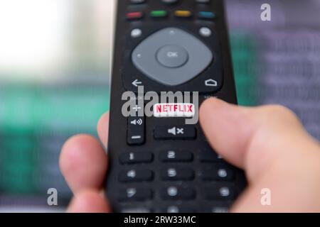 London. UK- 09.13.2023. A person using the remote control to access the popular streaming entertainment service provider Netflix. Stock Photo