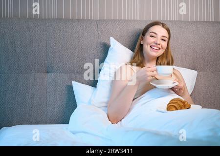 Attractive woman posing at camera in modern room Stock Photo