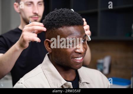 African American in a barbershop gets advice from a hairdresser Stock Photo