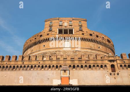 Exterior facade of the ancient towering rotunda of Castel Sant'Angelo or Mausoleum of Hadrian against a blue sky, in the historic old town of central Stock Photo