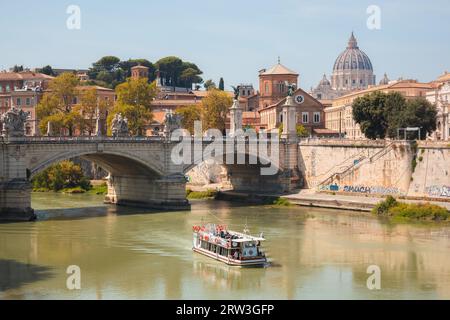 Rome, Italy: August 27, 223: Scenic view on a sunny summer day of a tourist boat cruise along the Tiber River past Saint Peter's Basilica, Vatican Cit