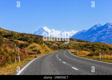 Driving on highway 80 leading to Mt Cook mountain range on shores of Lake Pukaki in New Zealand. Stock Photo