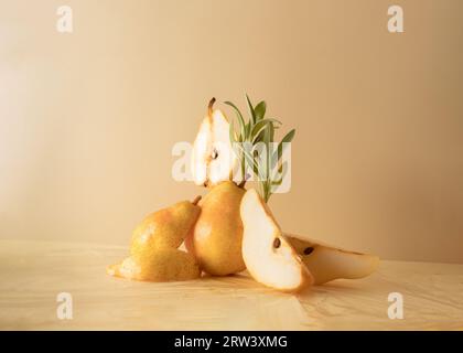 composition of pears and sprigs of sage on a beige background. Creative fruit food concept. Stock Photo