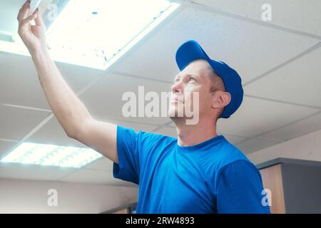 A Male Electrician Installing Fluorescent Lighting Ballast Stock Photo ...