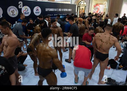 Bangkok, Thailand. 16th Sep, 2023. Athlete's assistant is painting tan on the body of a bodybuilding athlete, Before going on stage to compete at The Thailand Muscle and Physique Championships 2023 on September 16, 2023. at Central Rama 2 Department Store, Bangkok, Thailand. (Credit Image: © Teera Noisakran/Pacific Press via ZUMA Press Wire) EDITORIAL USAGE ONLY! Not for Commercial USAGE! Stock Photo