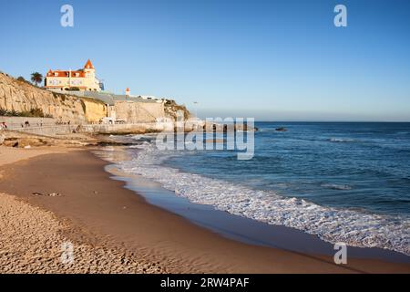 Beach, cliff and promenade along the Atlantic Ocean coast in resort town of Estoril in Portugal Stock Photo
