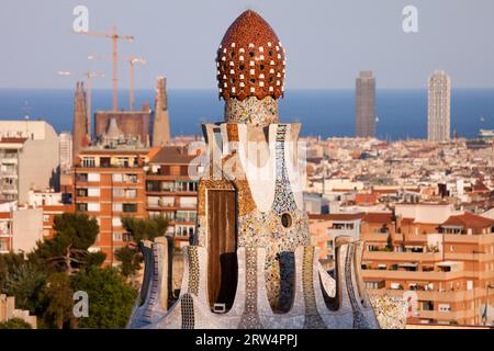 Top of the Casa del Guarda by Antoni Gaudi in Park Guell against Barcelona skyline in Catalonia, Spain Stock Photo