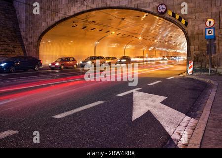 Night traffic, street tunnel at Solidarity Avenue (Polish: Aleja Solidarnosci) in city of Warsaw, Poland Stock Photo
