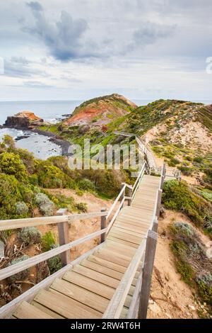 The famous Cape Schanck boardwalk runs towards the sea and rock formation known as London Bridge, in Victora. Australia Stock Photo