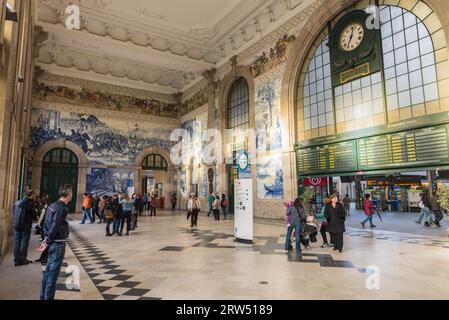 Porto, Portugal, April 26, 2014: The Sao Bento Railway Station in Porto city with the electronic scoreboard and the old clock inside it. The building Stock Photo