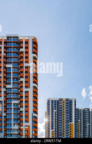 freshly built high rise apartment buildings on blue sky background with ...
