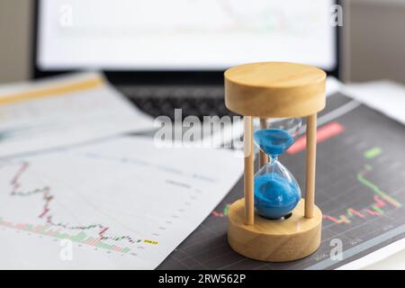 Hourglass on laptop computer concept for time management and countdown to deadline Stock Photo