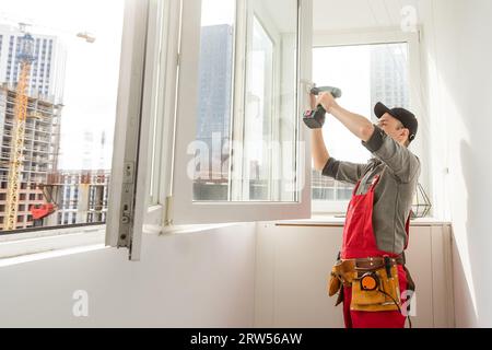 window installation wizard configures window closing Stock Photo