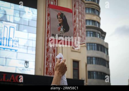 Madrid, Spain. 16th Sep, 2023. Iranian protester holds a placard with the face of Mahsa Amini during the demonstration. Iranian residents in Madrid have gathered in the Plaza de Callao to commemorate the first year of the death of the young Kurdish woman Mahsa Amini, who died after being detained by the Iranian morality police for not wearing the Islamic scarf properly and failed. Credit: SOPA Images Limited/Alamy Live News Stock Photo