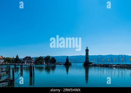 Lindau, Germany, June 14, 2023, Beautiful old harbor of the city with many ships anchoring in bodensee water with blue sky Stock Photo