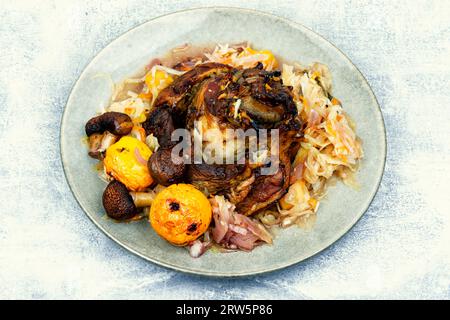 Pork knee baked in cabbage. Czech traditional food Stock Photo