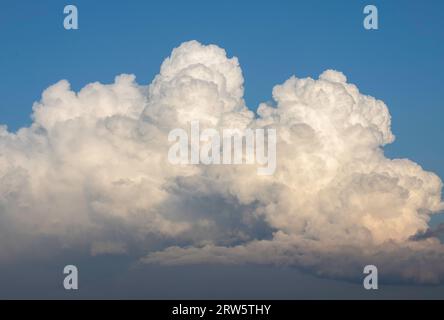 Dramatic colorful sky, before storm and during sunset. Huge clouds formations above residential blocks Stock Photo
