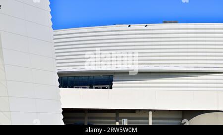 Minimalist photo of an exterior of a modern tin building with big glass showcases. Stock Photo