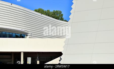 Minimalist photo of an exterior of a modern tin building with big glass showcases. Stock Photo