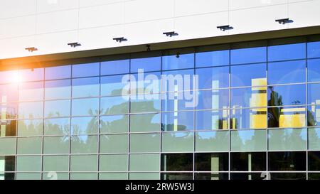 Minimalist photo of an exterior of a modern tin building with big glass showcases. Stock Photo