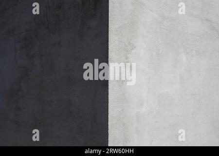 The corner of the house is covered with gray putty, the light and dark side of the wall Stock Photo