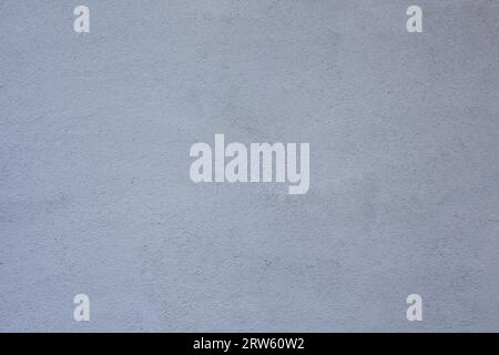 The background is a concrete wall painted white. Stock Photo