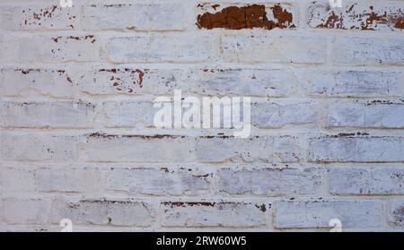 The old adobe wall is painted white. Stock Photo