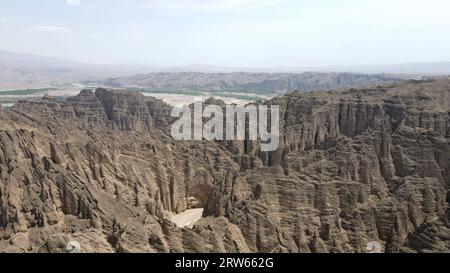 (230917) -- LANZHOU, Sept. 17, 2023 (Xinhua) -- This aerial photo taken on July 11, 2023 shows the Yellow River Stone Forest in Jingtai County of Baiyin City, northwest China's Gansu Province. The Yellow River, originating from the Bayan Har Mountains, meanders thousands of miles in Gansu. On both sides of the river, ancient cities, towns and villages formed and prospered, and became important guardians and inheritors of the Yellow River culture. In recent years, Gansu Province has continuously strengthened the preservation and revitalization of ancient cities, towns and villages along the Y Stock Photo