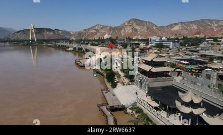 (230917) -- LANZHOU, Sept. 17, 2023 (Xinhua) -- This aerial photo taken on July 9, 2023 shows a view of Hekou ancient town in Lanzhou, northwest China's Gansu Province. The Yellow River, originating from the Bayan Har Mountains, meanders thousands of miles in Gansu. On both sides of the river, ancient cities, towns and villages formed and prospered, and became important guardians and inheritors of the Yellow River culture. In recent years, Gansu Province has continuously strengthened the preservation and revitalization of ancient cities, towns and villages along the Yellow River, protecting Stock Photo