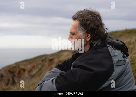 adult man with gray hair, thoughtful in nature Stock Photo