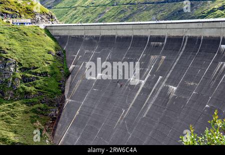 climber on the dam wall Drossensperre of the storage lake Mooserboden in the national park High Tauern in Salzburg, Austria Stock Photo