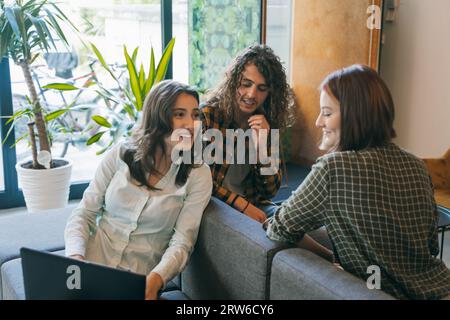 Beautifu, young businesspeople having fun conversation and smiling while working together Stock Photo