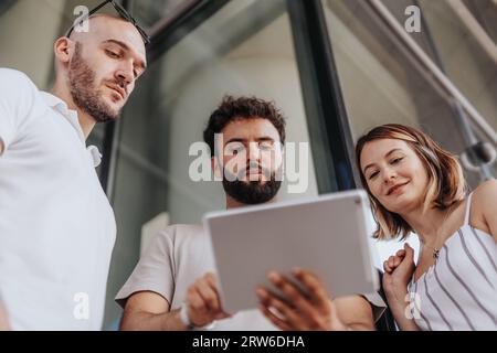 Diverse professionals collaborating outdoors, planning strategies, and reviewing reports for their company. Stock Photo
