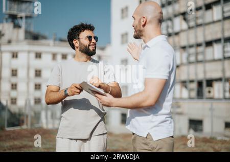 Architects Collaborating on Blueprint for Modern Building Design Stock Photo
