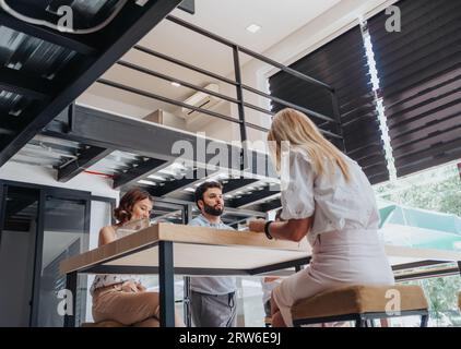 Different aged team of confident business people working in a creative office, analyzing reports, conducting market research, and developing a strateg Stock Photo