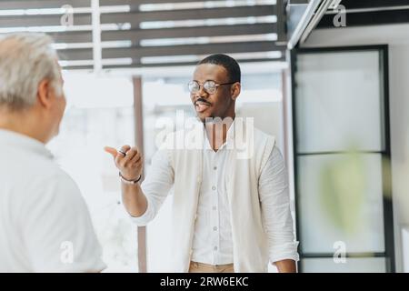 A dynamic business meeting with diverse professionals discussing growth strategies, collaborating on innovative ideas, and sharing feedback for better Stock Photo