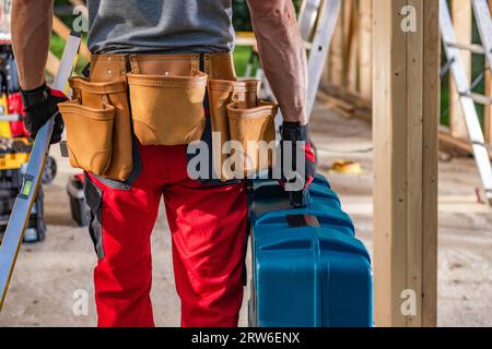 Caucasian Construction Contractor Moving His Equipment and Tools on the Site Stock Photo