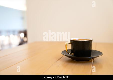 Cup of hot coffee on the wooden table. Stock Photo