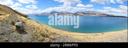 Lake Tekapo panorama taken from part of the Mt John Summit Circuit Track. The photo looks east across the water to the Two Thumb mountain range. Stock Photo