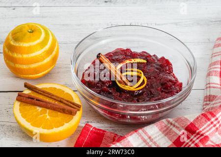 Homemade cranberry sauce in a glass bowl close-up on kitchen table Stock Photo
