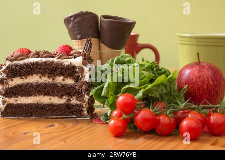 Healthy eating versus an unhealthy choice of chocolate layer cake Stock Photo